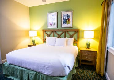 Bedroom with bed and window in a two-bedroom villa at South Beach Resort in Myrtle Beach, South Carolina.