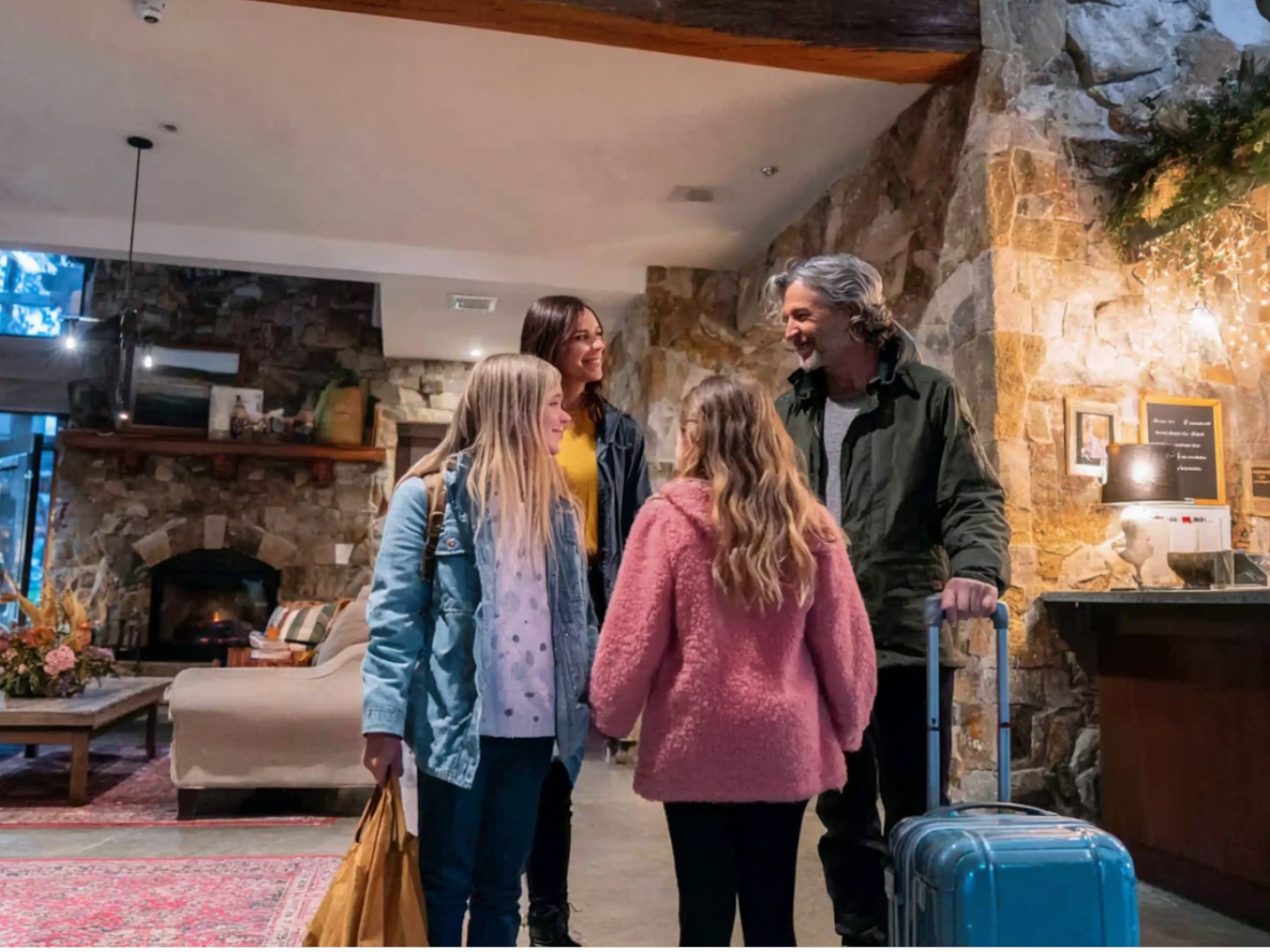 Family checking into Hilton Branson Convention Center hotel, featuring welcoming lobby and stone décor