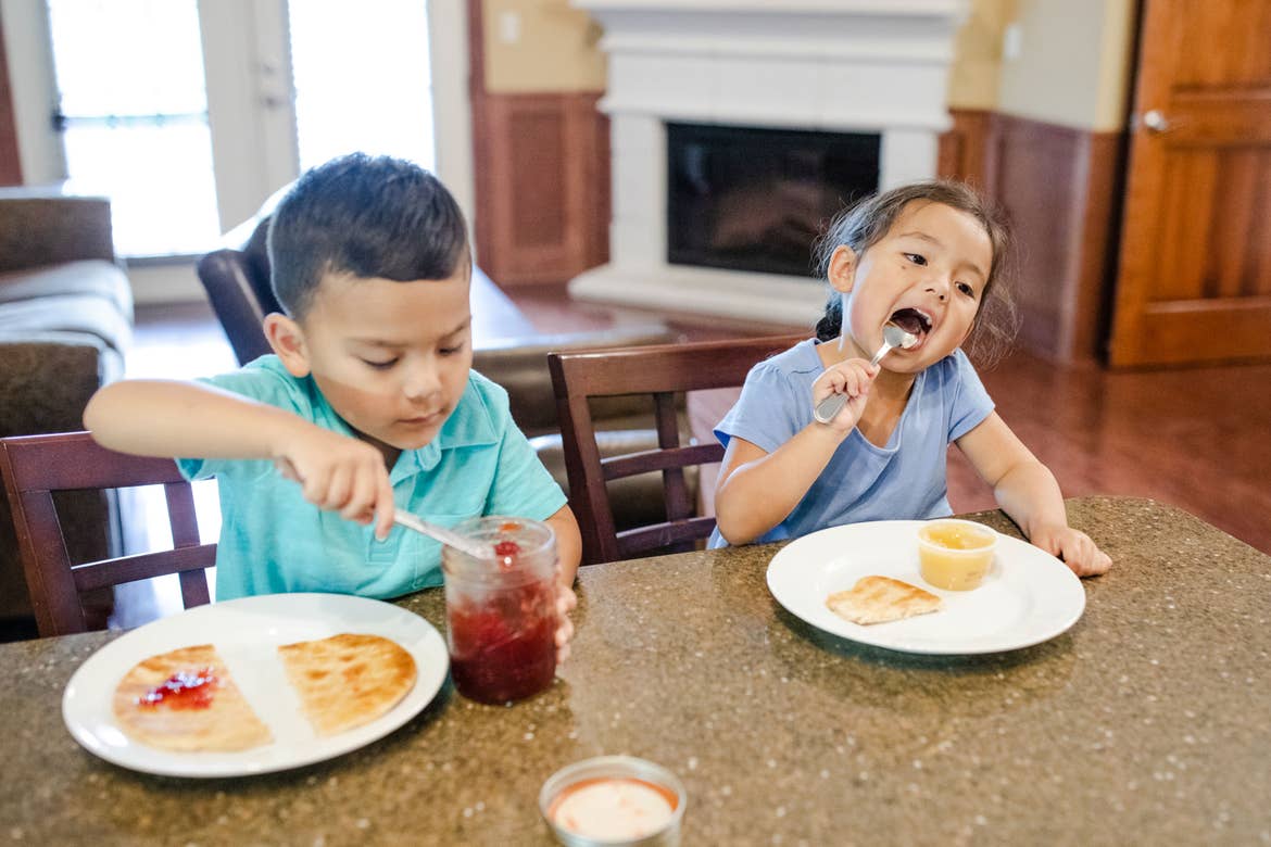 Angelica Kajiwara's kids enjoying snack time at our Holiday Hills Branson Resort at the kitchen countertop.