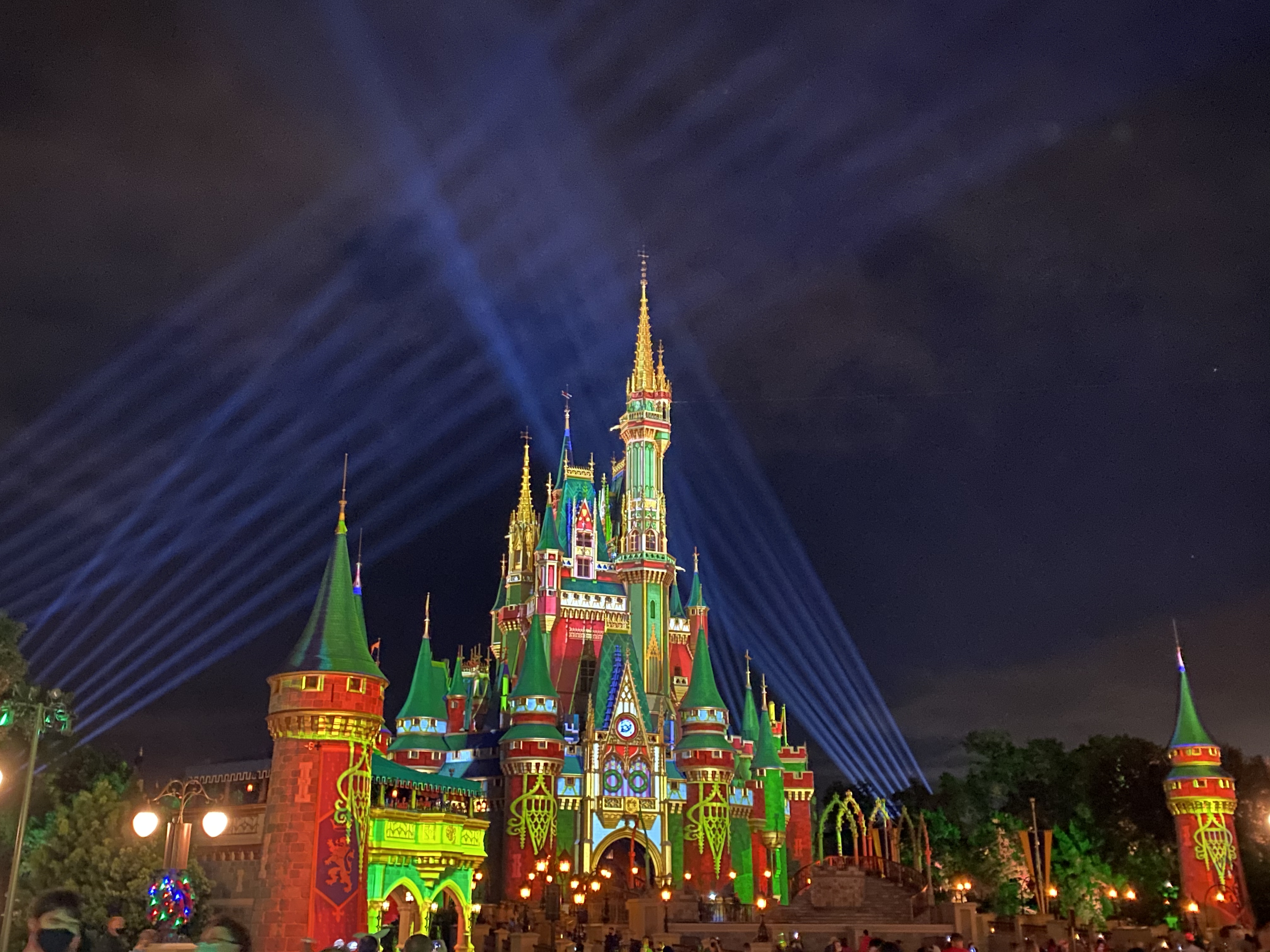 Cinderella's Castle at Magic Kingdom Park at Walt Disney World® Resort is illuminated with holiday projections at night.