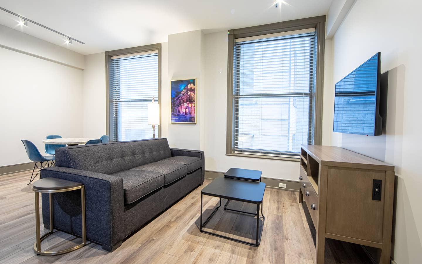 Two bedroom villa living area with couch, two windows and TV at New Orleans Resort in Louisiana.