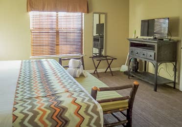 Bedroom with TV in a two-bedroom villa at the Holiday Hills Resort in Branson Missouri.