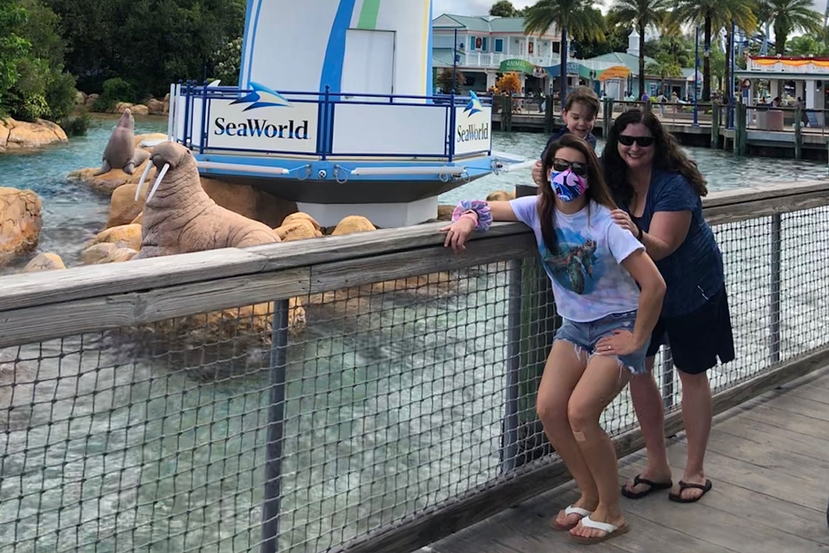 Jennifer Harmon, Theresa and son are posed in front of the SeaWorld Orlando Lighthouse.
