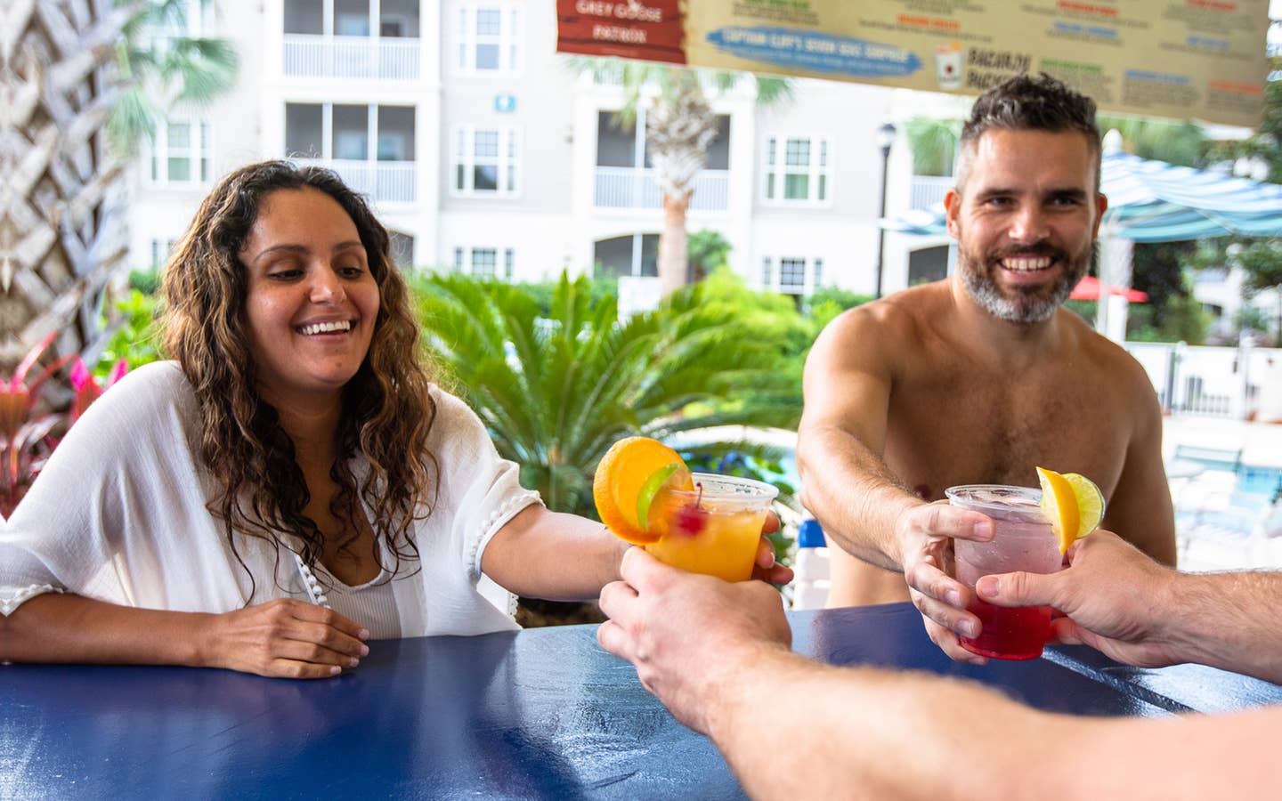 Two adults getting drinks at outdoor pool bar at South Beach Resort in Myrtle Beach, South Carolina.