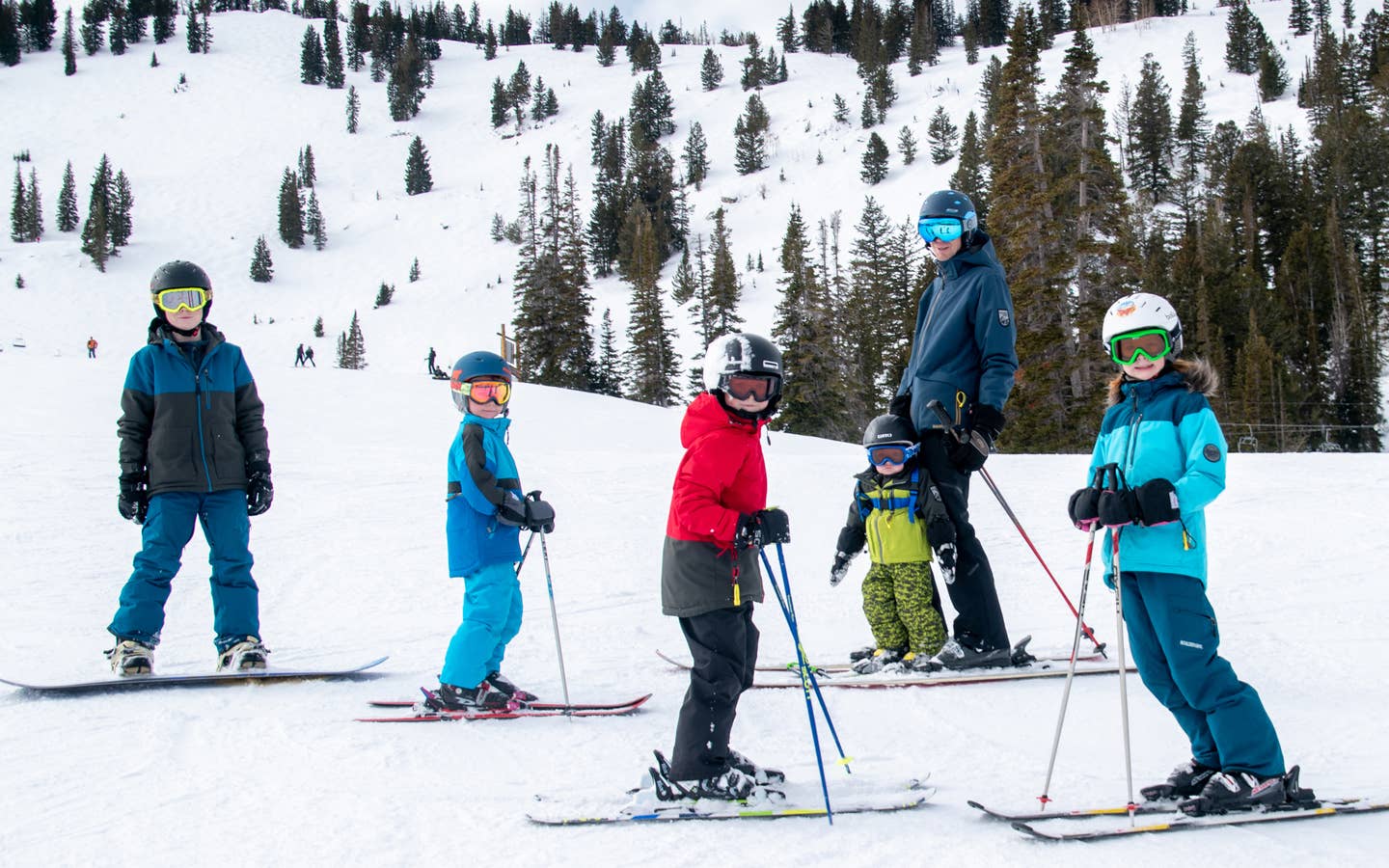 Featured Contributor, Jessica Averett's family, adorn with ski gear, make their way down the snowy slopes.