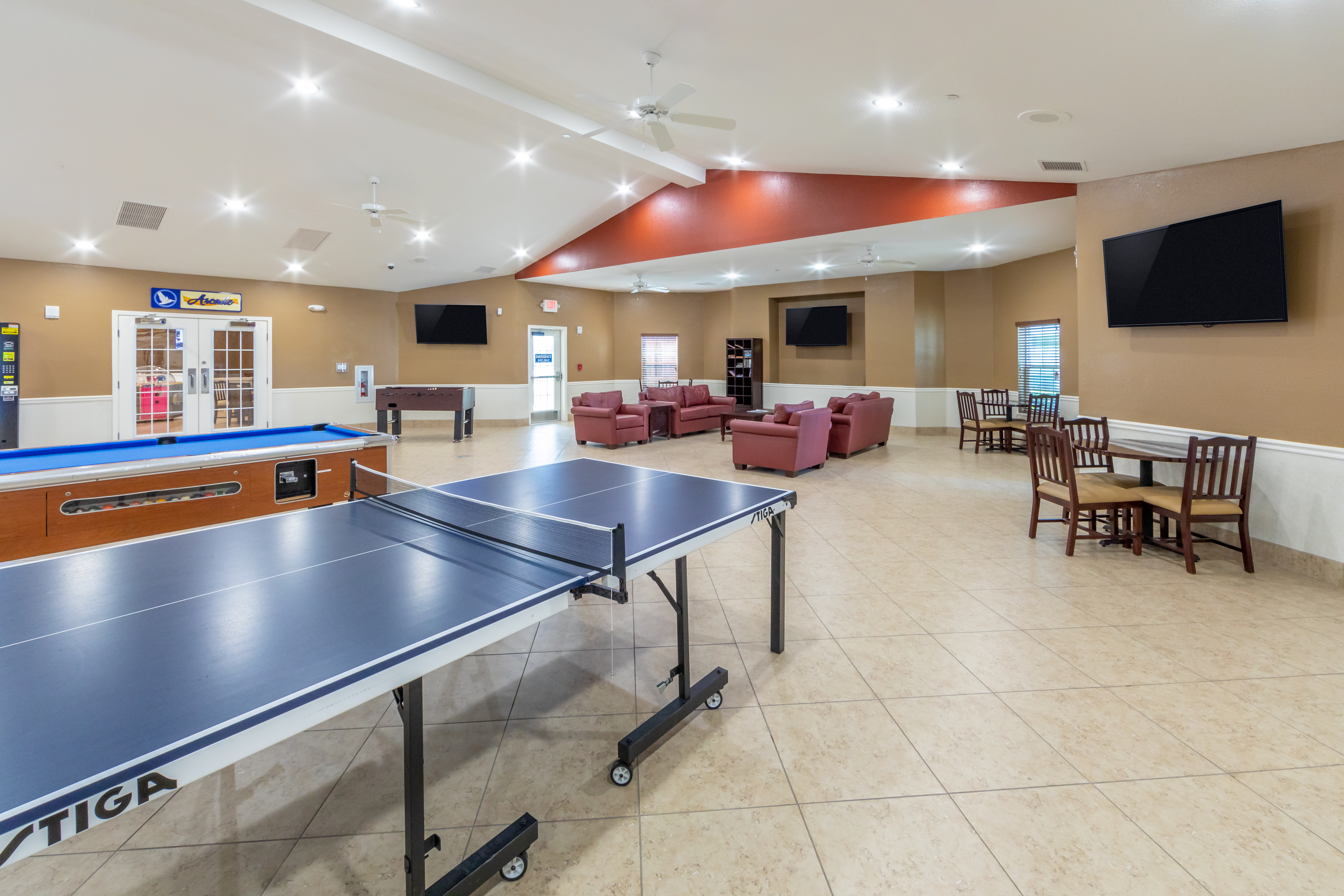 Activity center with pool table, ping pong table and flat screen TVs at Orlando Breeze Resort in Florida.