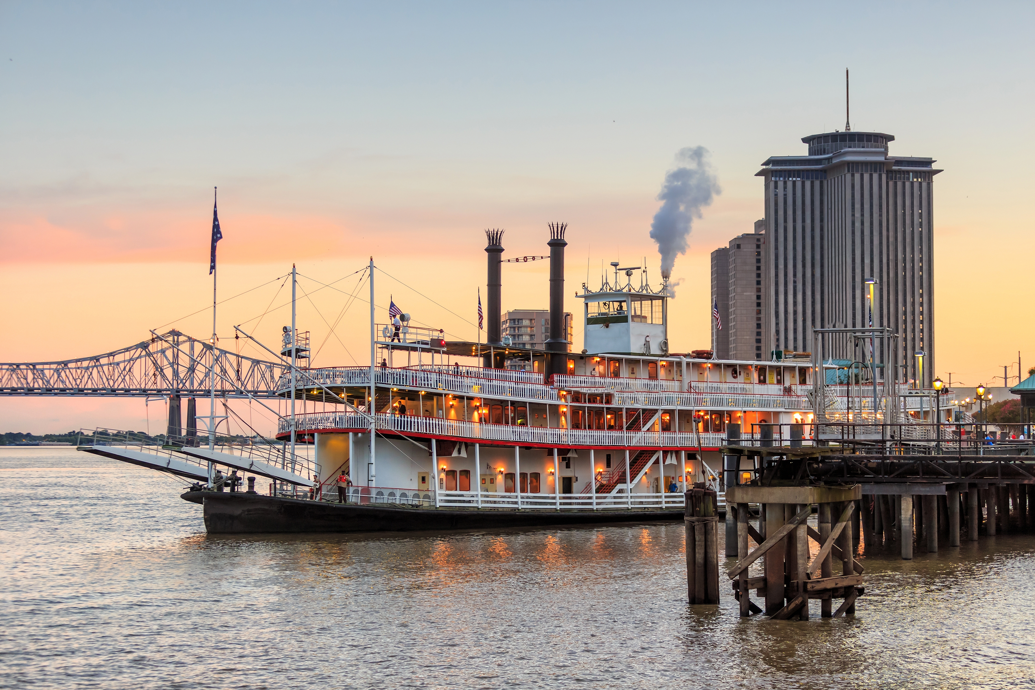 New Orleans Steamboat and bridge at sunset.