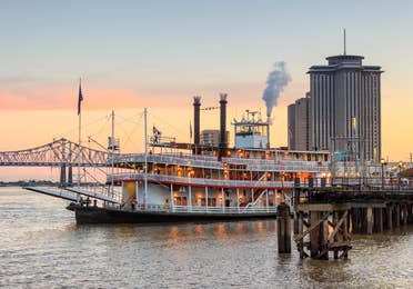 New Orleans Steamboat and bridge at sunset.