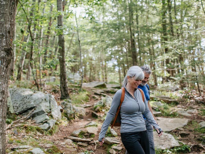 Older couple walking on a nature trail.