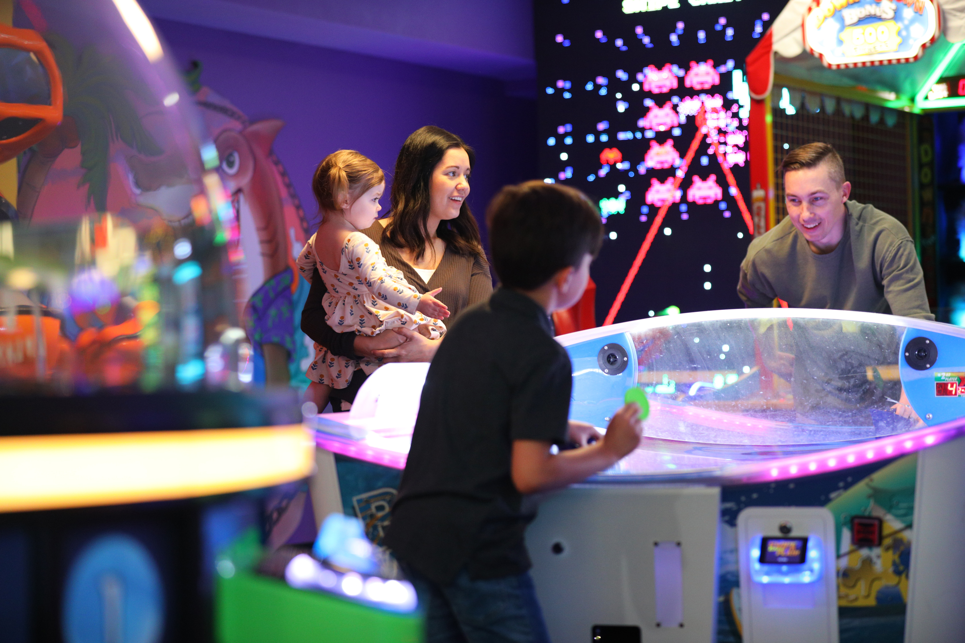Mia St Clair and her family playing games at the arcade at Orange Lake Resort