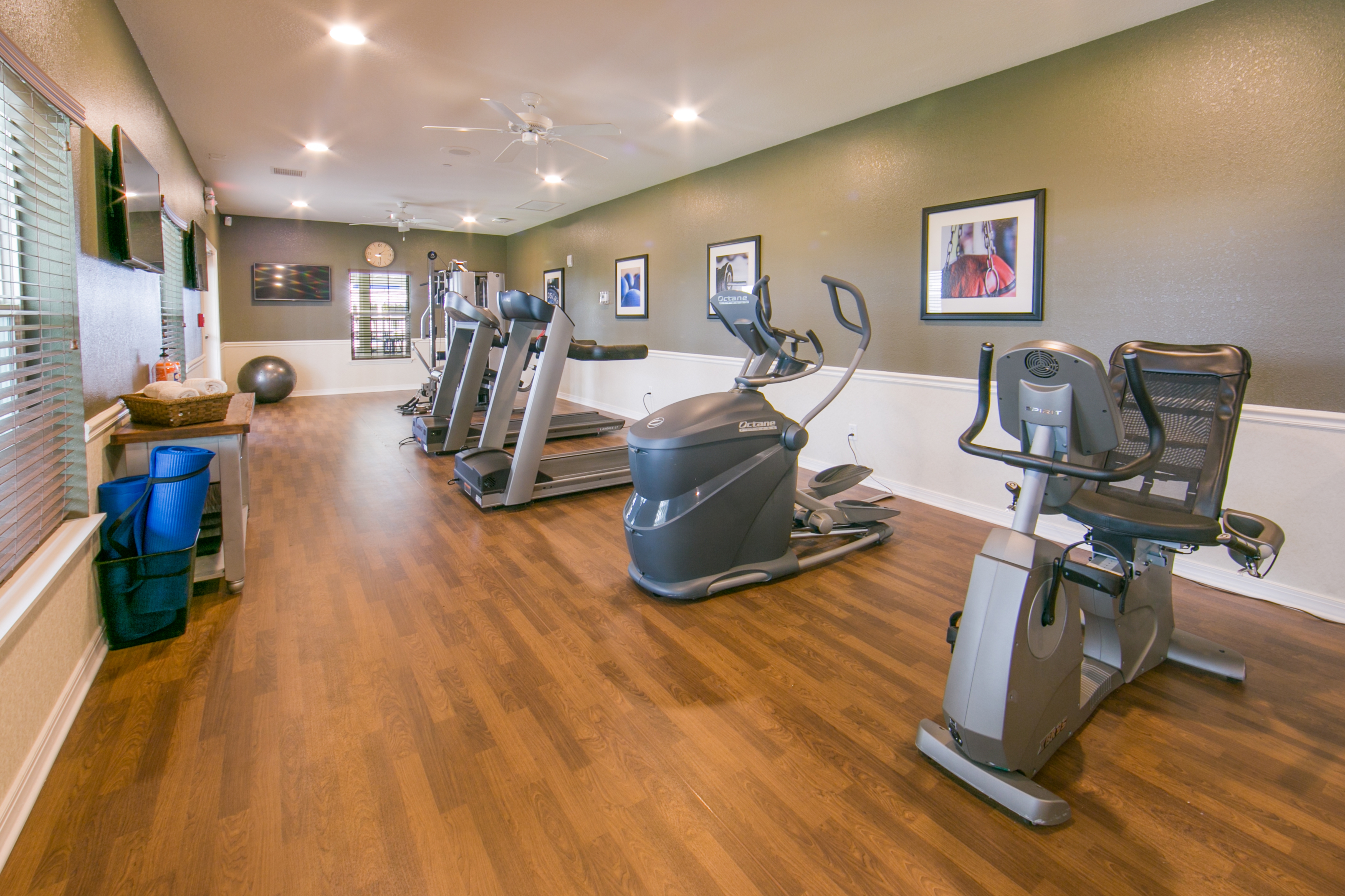 Fitness center with treadmills and ellipticals at Orlando Breeze Resort in Florida.