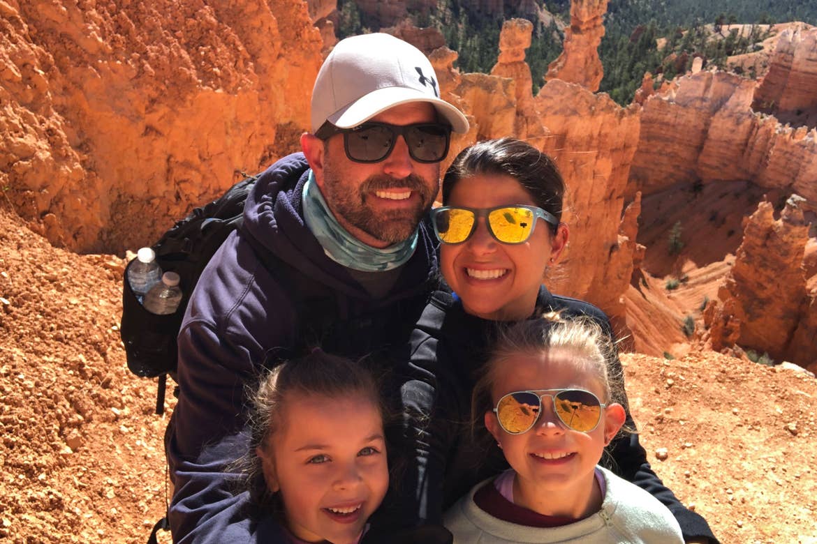 Author, Chris Johnston (top-right), stands in front of the rock formations at Bryce Canyon National Park with her husband, Josh (top-left), and daughters, Kyndall (front-right), and Kyler (front-left).