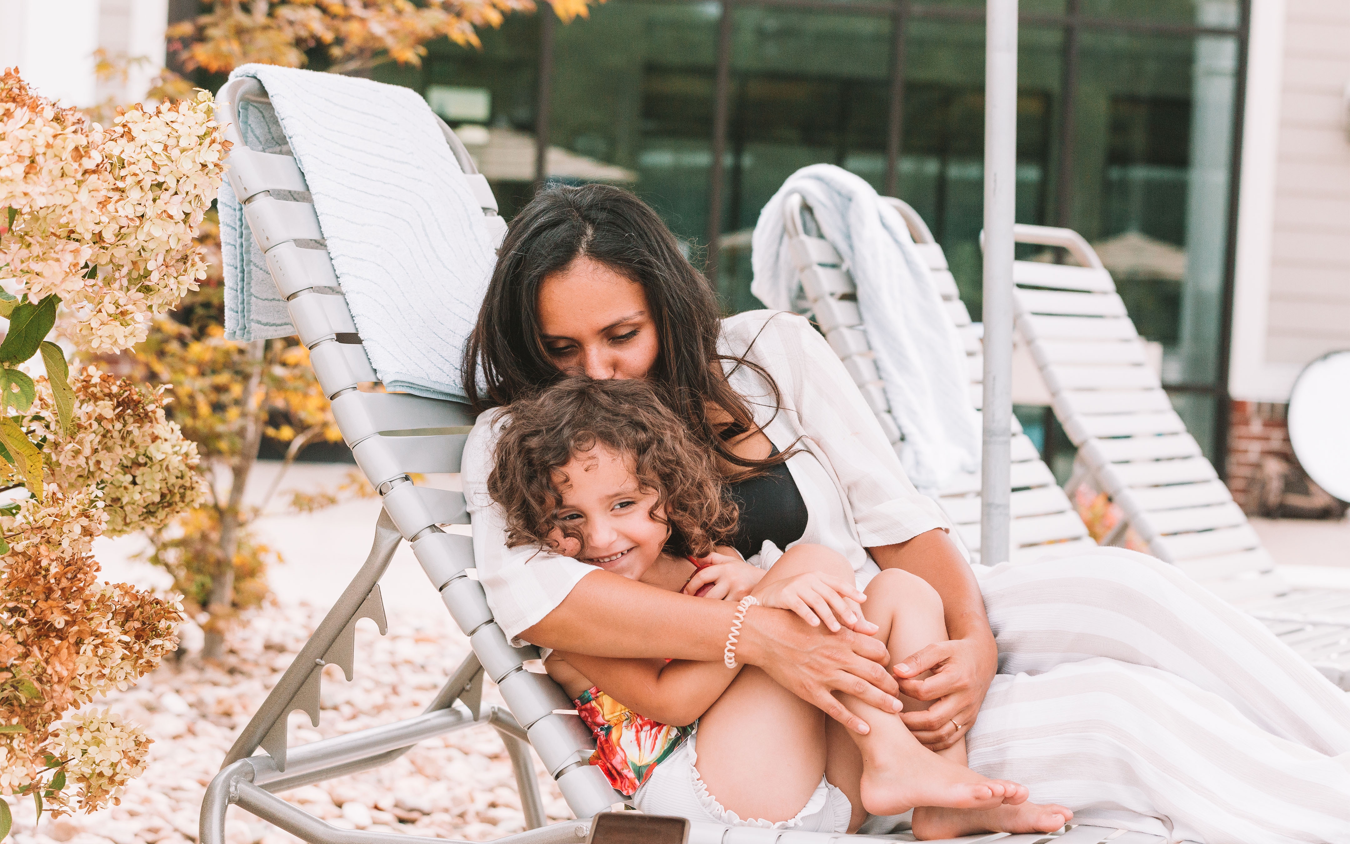 Mother snuggling child outside of pool at Williamsburg Resort.