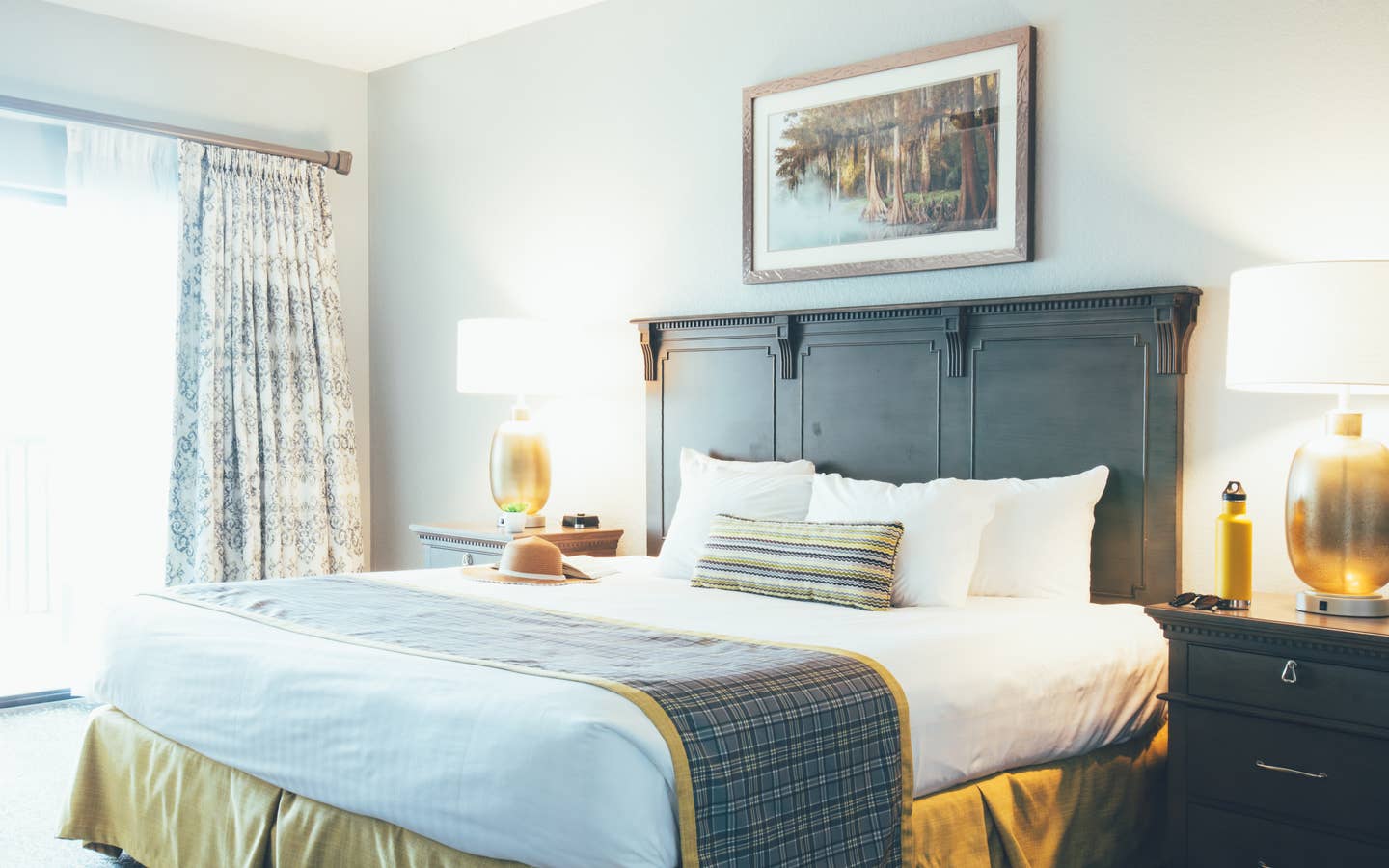 Bedroom with two night stands and a large window in a villa in River Island at Orange Lake Resort near Orlando, Florida