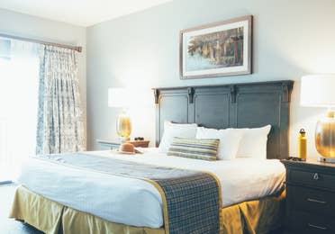 Bedroom with two night stands and a large window in a villa in River Island at Orange Lake Resort near Orlando, Florida