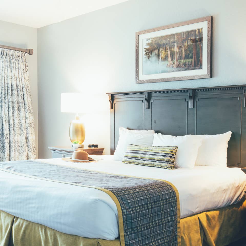 Bedroom with two night stands and a large window in a villa in River Island at Orange Lake Resort near Orlando, Florida
