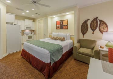 Bedroom with a kitchenette in a two-bedroom presidential villa at Villages Resort