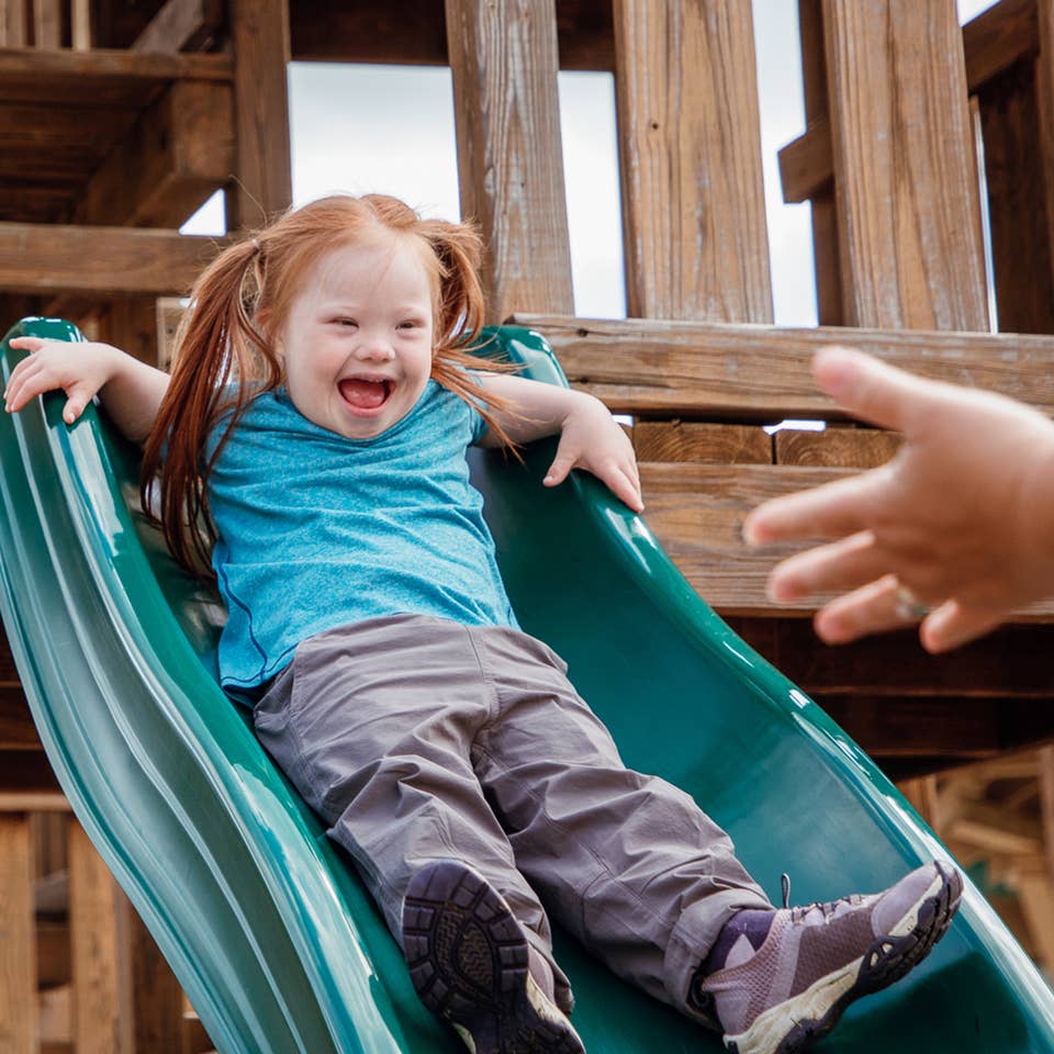 Young girl going down playground slide at Oak n' Spruce Resort in South Lee, Massachusetts.
