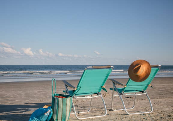 Two beach chairs sitting on beach near Cape Canaveral Beach Resort in Florida.