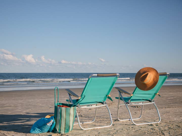 Two beach chairs sitting on beach near Cape Canaveral Beach Resort in Florida.