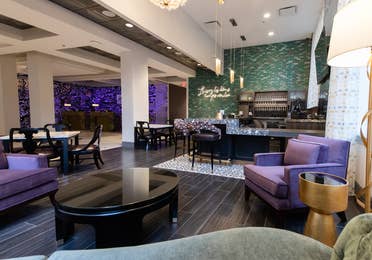 Maritime Bar & Lounge and seating area with purple chairs near the front near at New Orleans Resort in Louisiana.