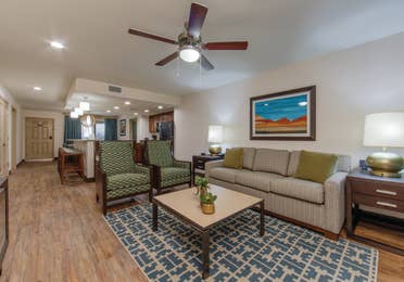 Living room with couch and two accent chairs in a three-bedroom villa at Scottsdale Resort