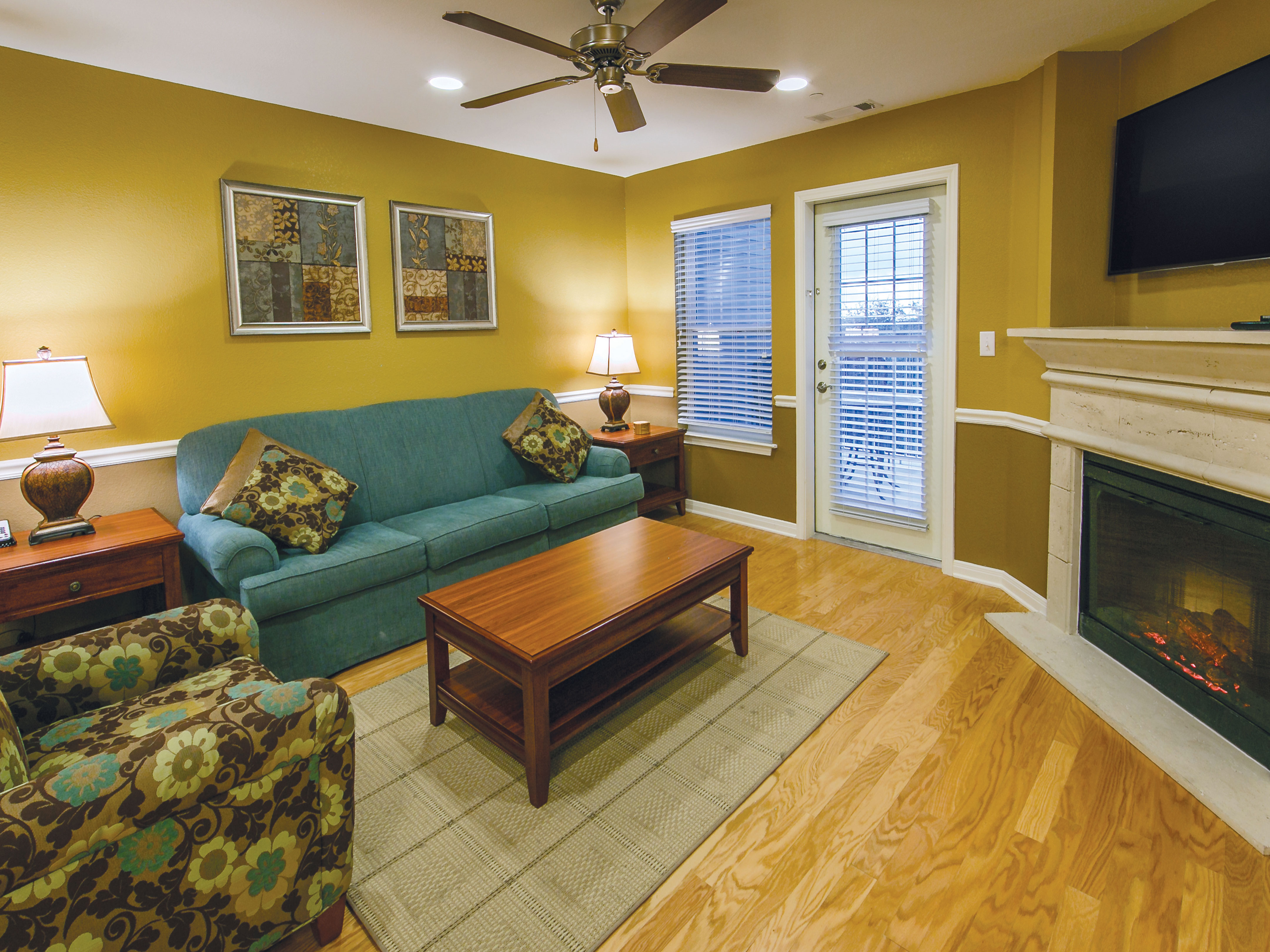 Living room with fireplace in a two-bedroom ambassador villa at the Hill Country Resort in Canyon Lake, Texas.