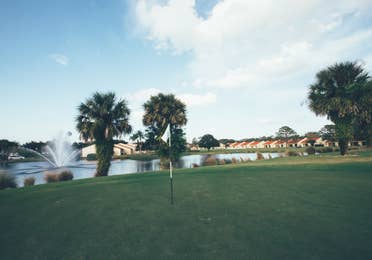 Golf course with lake fountain in the background in West Village at Orange Lake Resort near Orlando, Florida.
