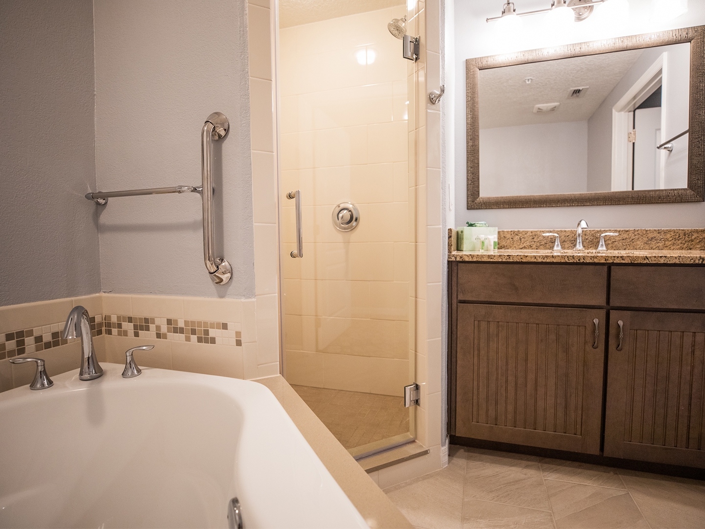 Bathroom with a tub and walk-in shower in a villa at Cape Canaveral Beach Resort.