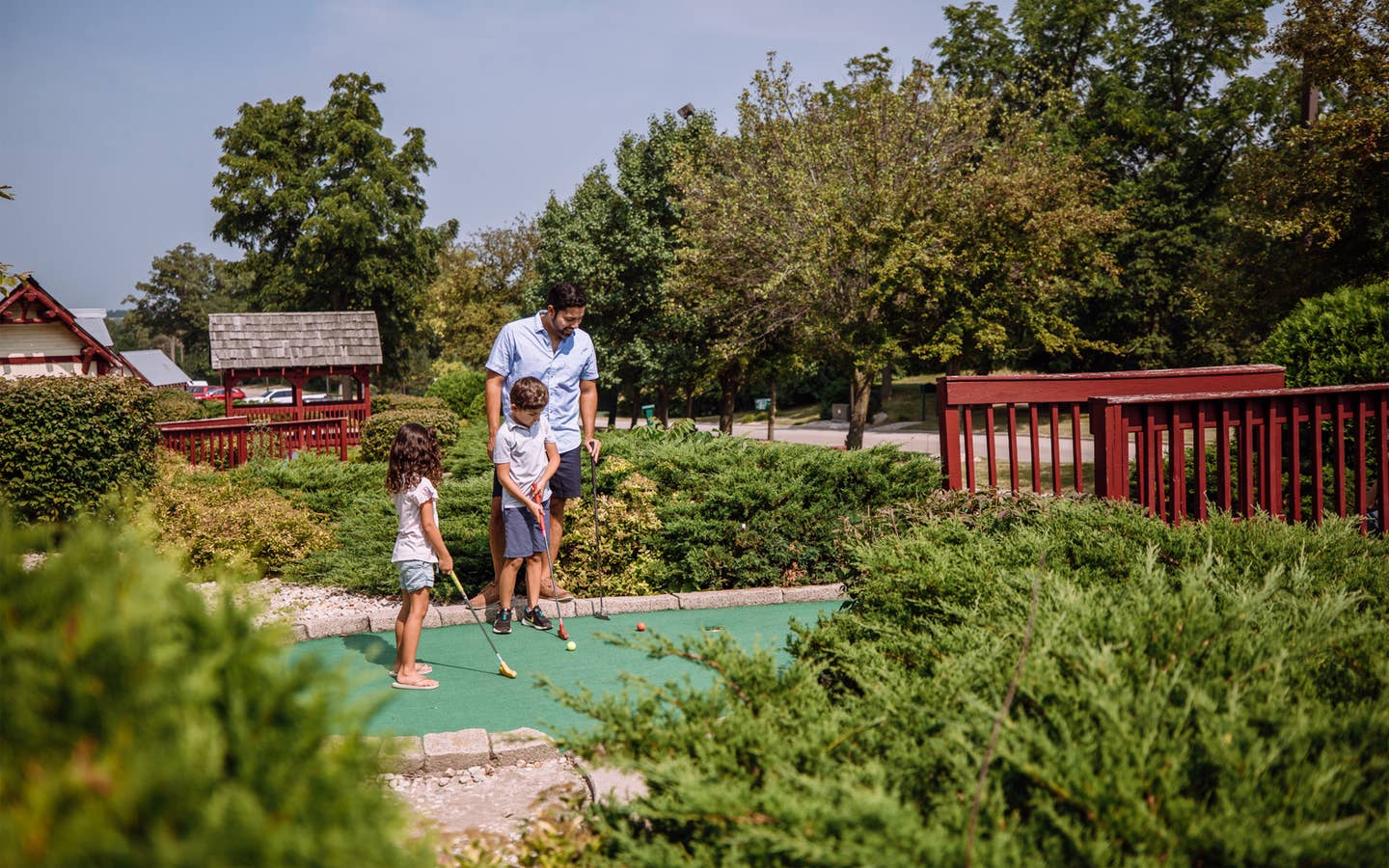 Family playing mini golf at Fox River Resort in Sheridan, Illinois.