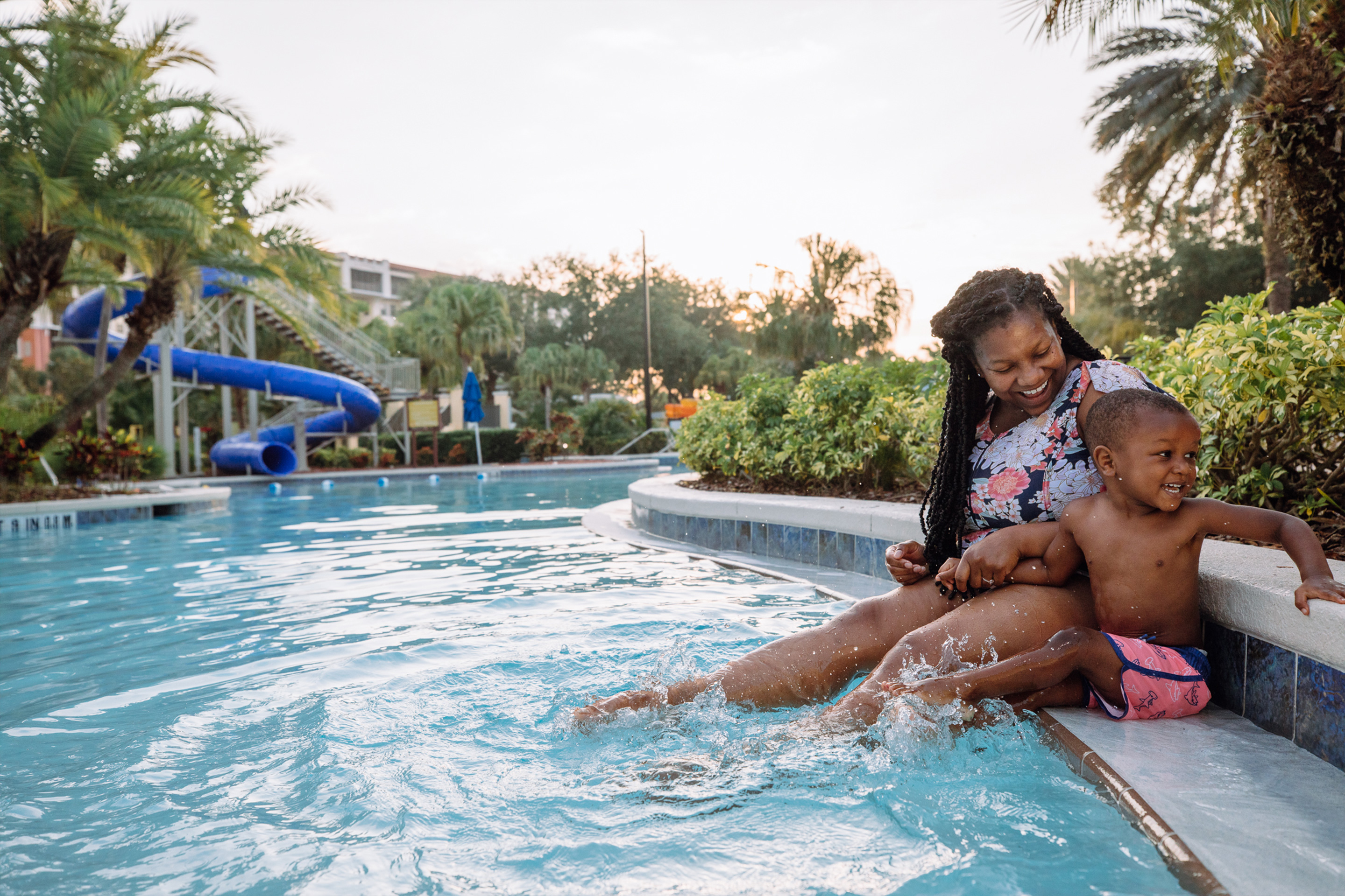 Featured Contributor, Krystin Godfrey (left) and her son (right) sit along the edge of our zero-entry pool in River Island at our Orange Lake resort located in Orlando, FL.