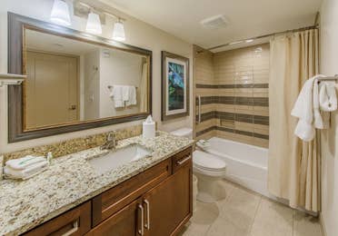 Full bathroom with shower/tub combination, sink with mirror, and toilet in a one-bedroom villa at Scottsdale Resort