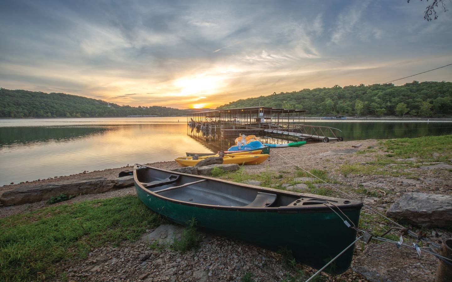 View of boat dock and lake at sunset at Ozark Mountain Resort in Kimberling City, MIssouri.