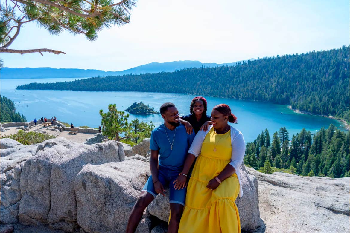 Karen and her family at Emerald Bay State Park with the gorgeous forest, mountains and lake as a backdrop.