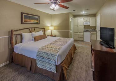 Bed in a  two-bedroom lock-off with a view of the kitchenette at Villages Resort