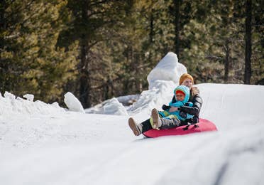 family sledding at the activity center near Lake Geneva Resort, Lake Geneva, WI.