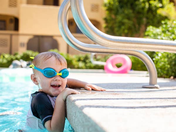 Young child wearing goggles in pool at Scottsdale Resort in Scottsdale, Arizona.