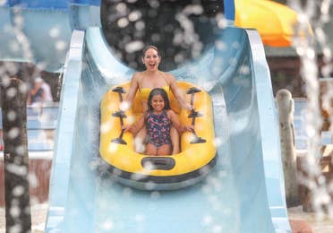 Family tubing down a water slide near Hill Country Resort in Canyon Lake, Texas