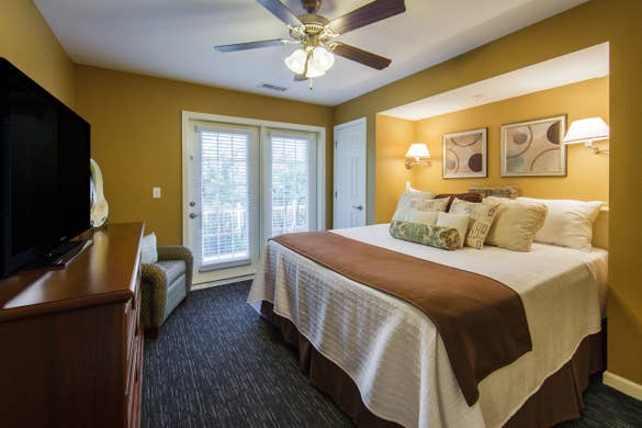 Bedroom with TV in a three-bedroom ambassador villa at the Holiday Hills Resort in Branson Missouri.