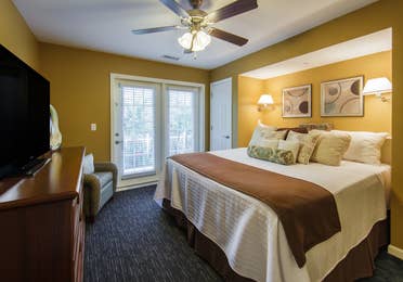 Bedroom with TV in a three-bedroom ambassador villa at the Holiday Hills Resort in Branson Missouri.