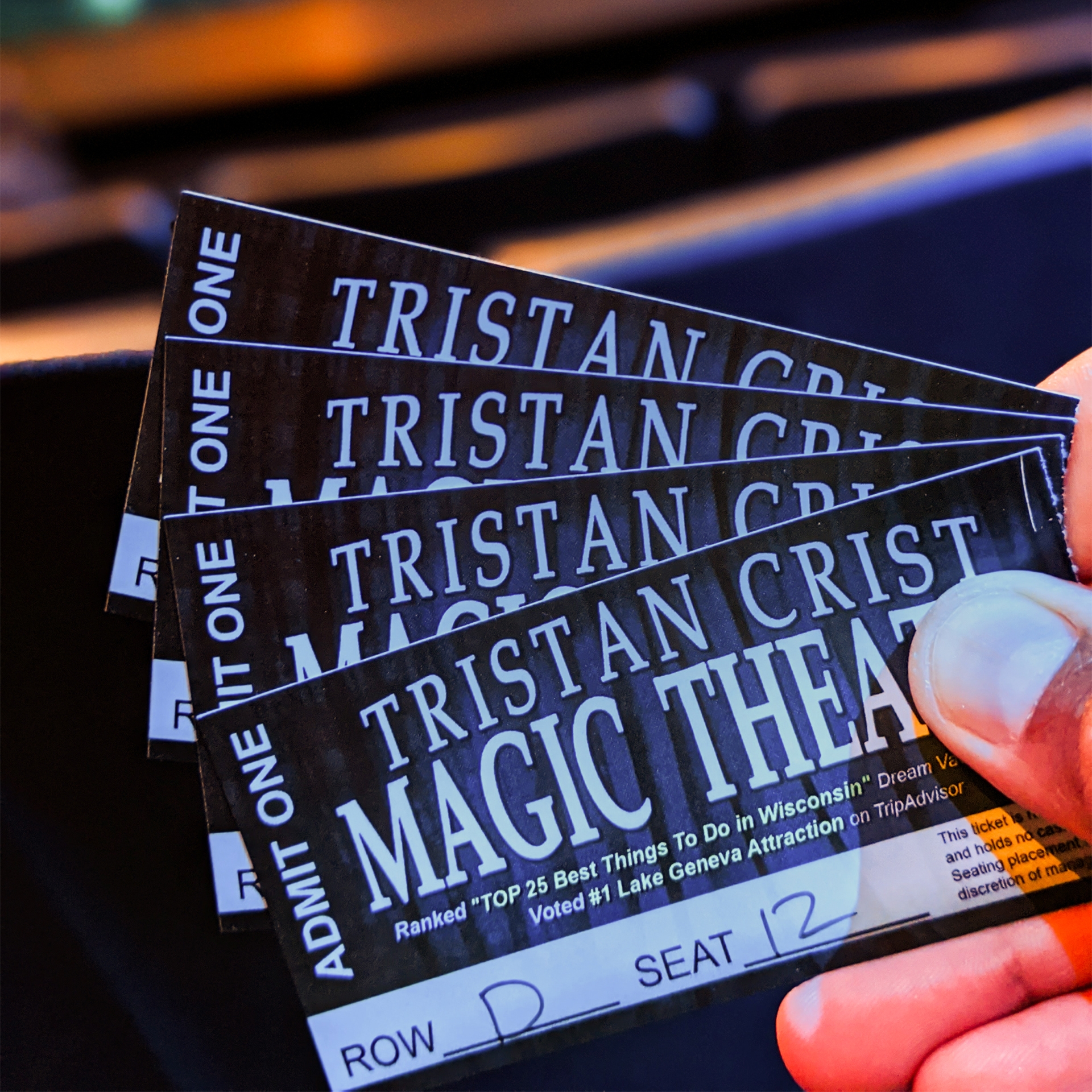 A hand holding tickets.