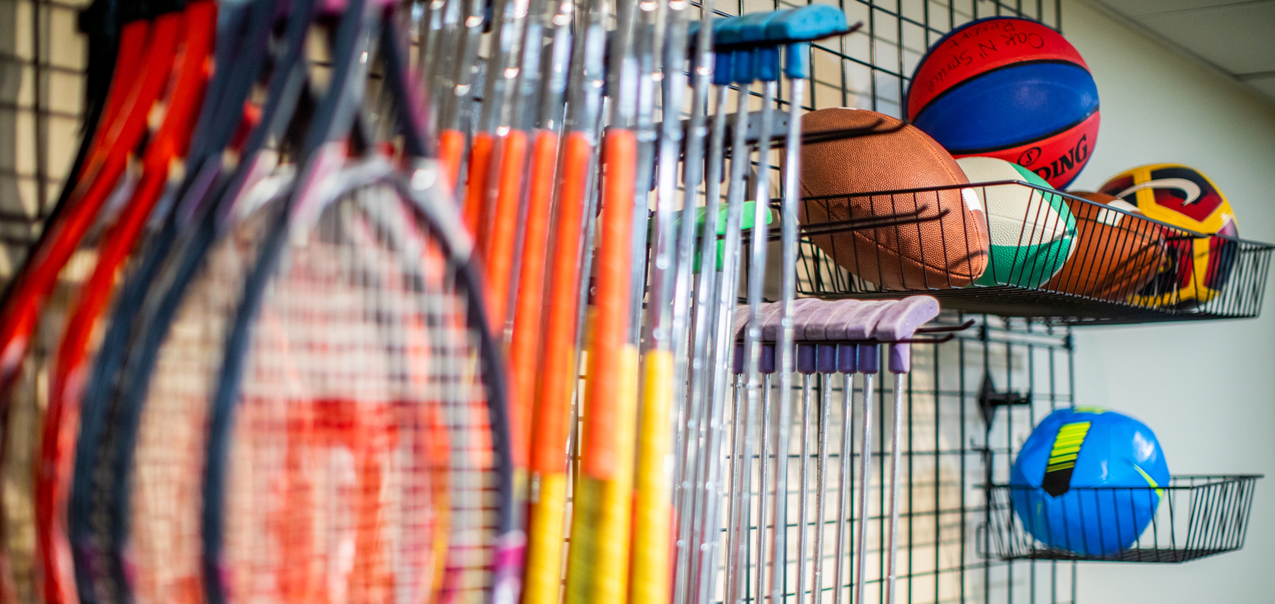 Tennis racket, putters, footballs, soccer balls and basketballs at the Marketplace at Oak n' Spruce Resort in South Lee, Massachusetts.