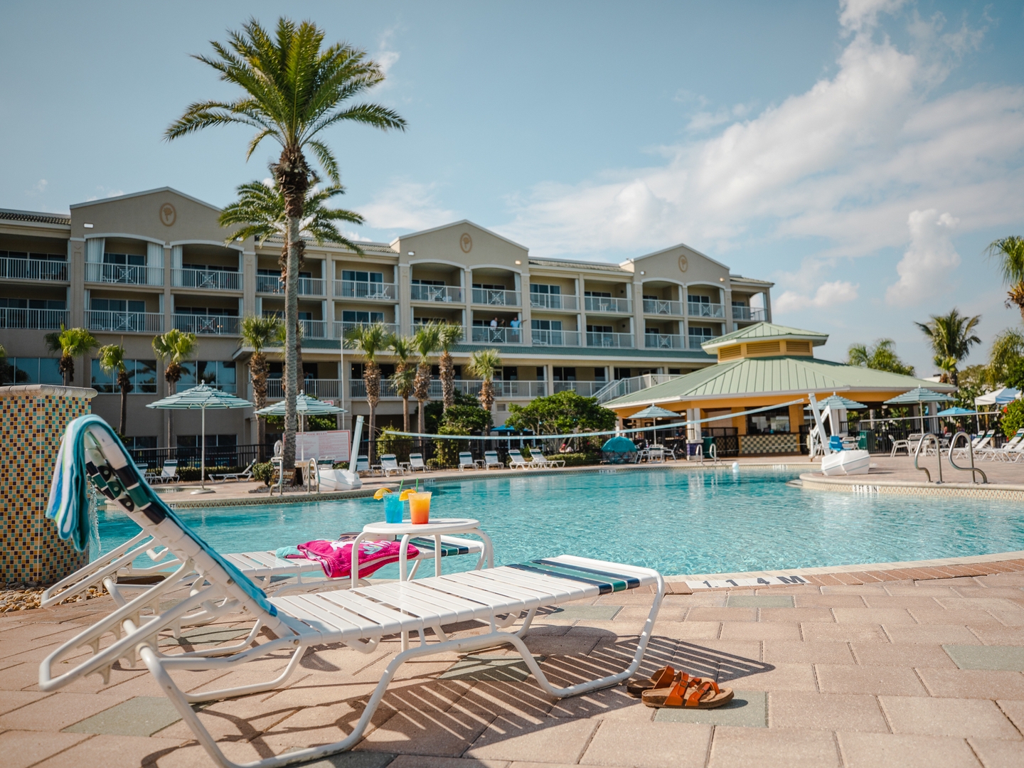 Pool chairs by pool at Cape Canaveral Beach Resort in Florida.