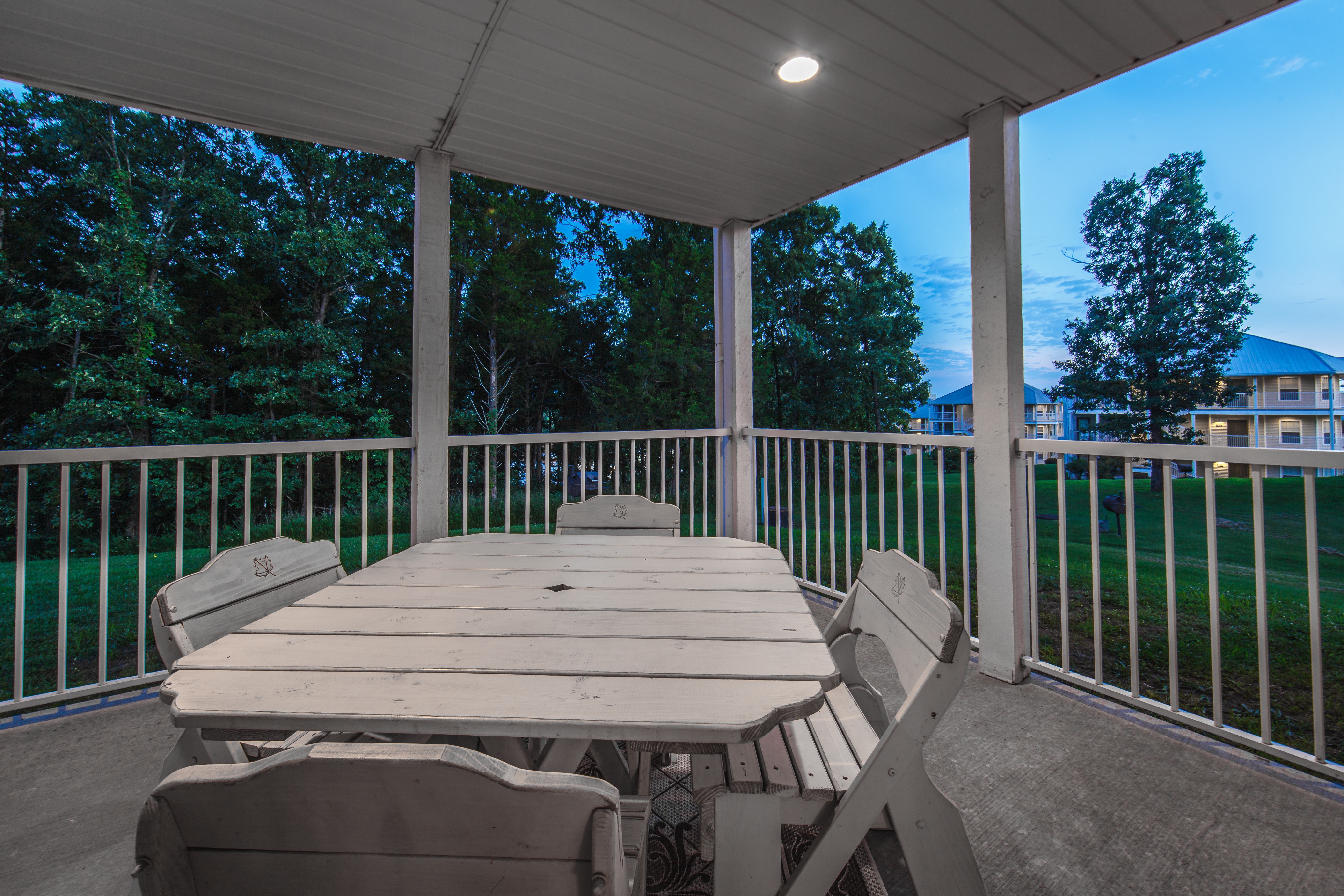 Porch with an outdoor table in a two-bedroom presidential villa at the Holiday Hills Resort in Branson Missouri.