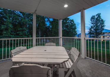 Porch with an outdoor table in a two-bedroom presidential villa at the Holiday Hills Resort in Branson Missouri.
