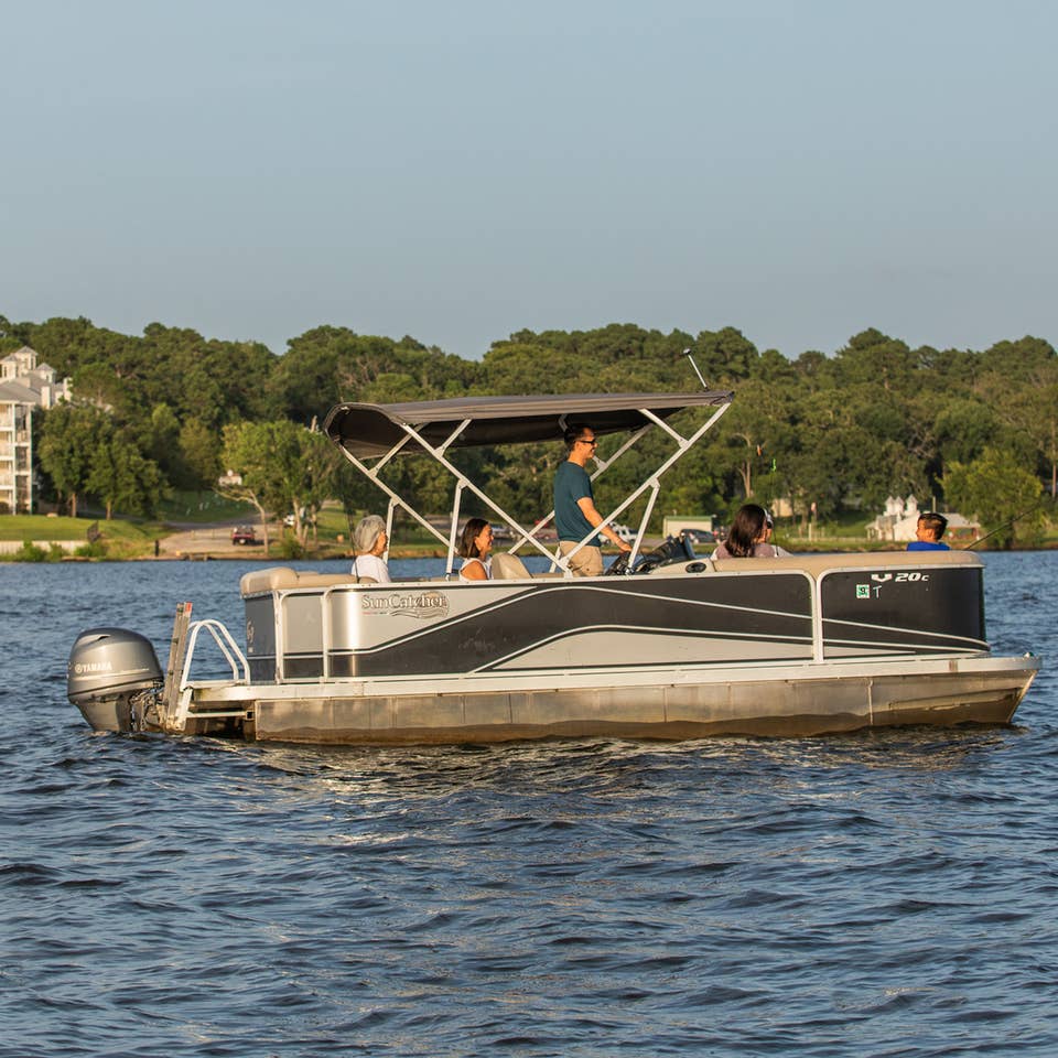 Family riding on pontoon boat at Villages Resort in Flint, Texas.