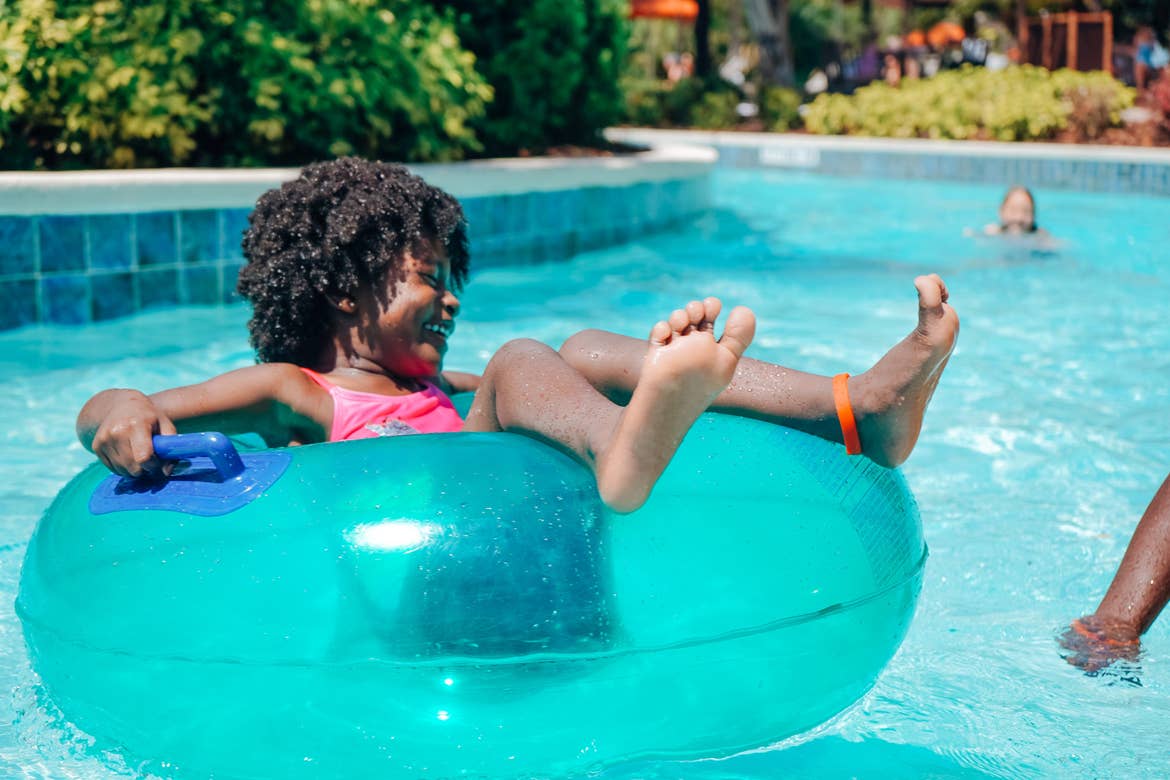 A young girl floats along our lazy river at Orange Lake Resort located in Orlando, FL.