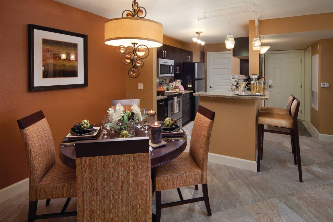 Kitchen and dining area in a one-bedroom villa at Desert Club Resort in Las Vegas
