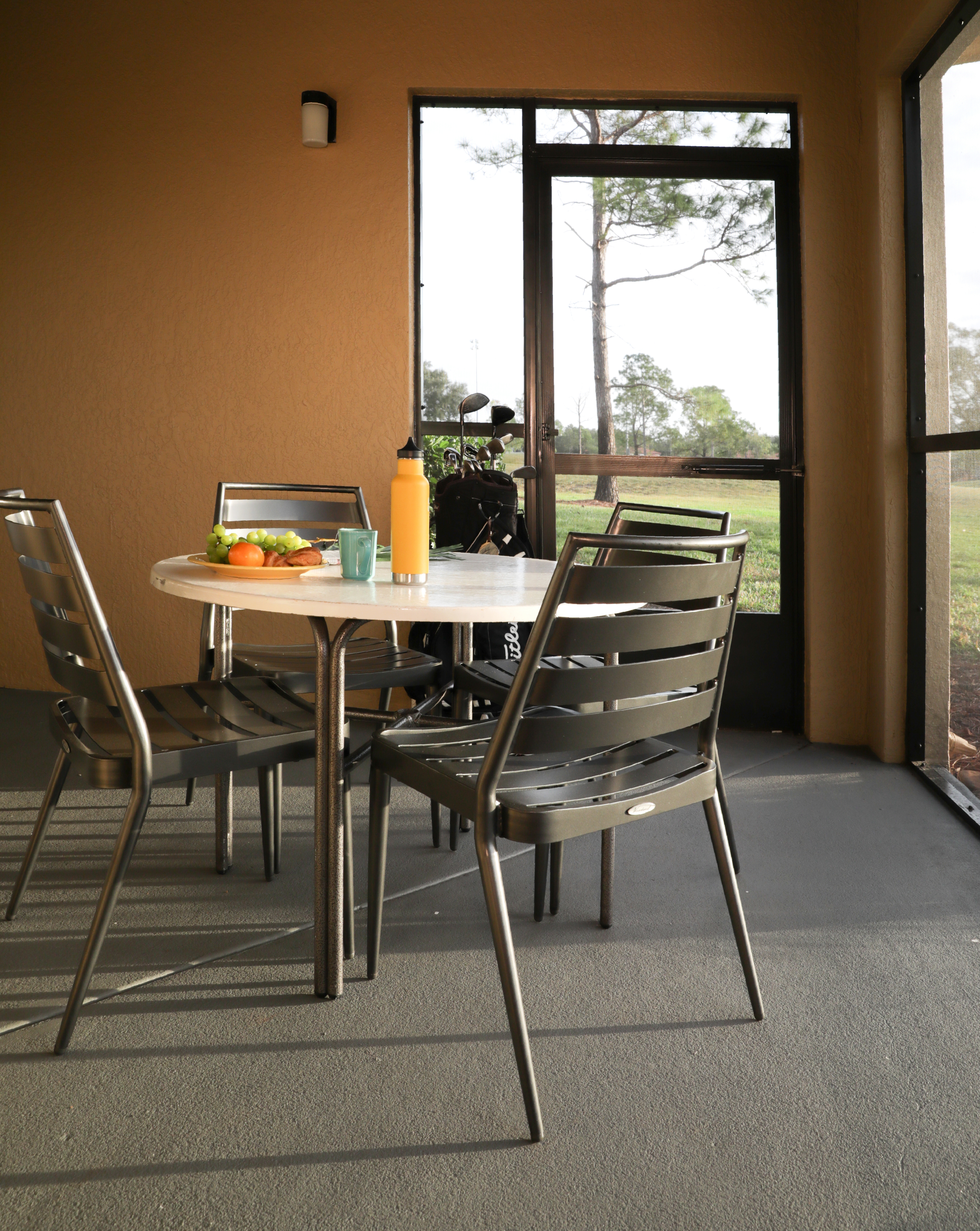 Furnished balcony with table and four chairs in a villa in North Village at Orange Lake Resort near Orlando, Florida