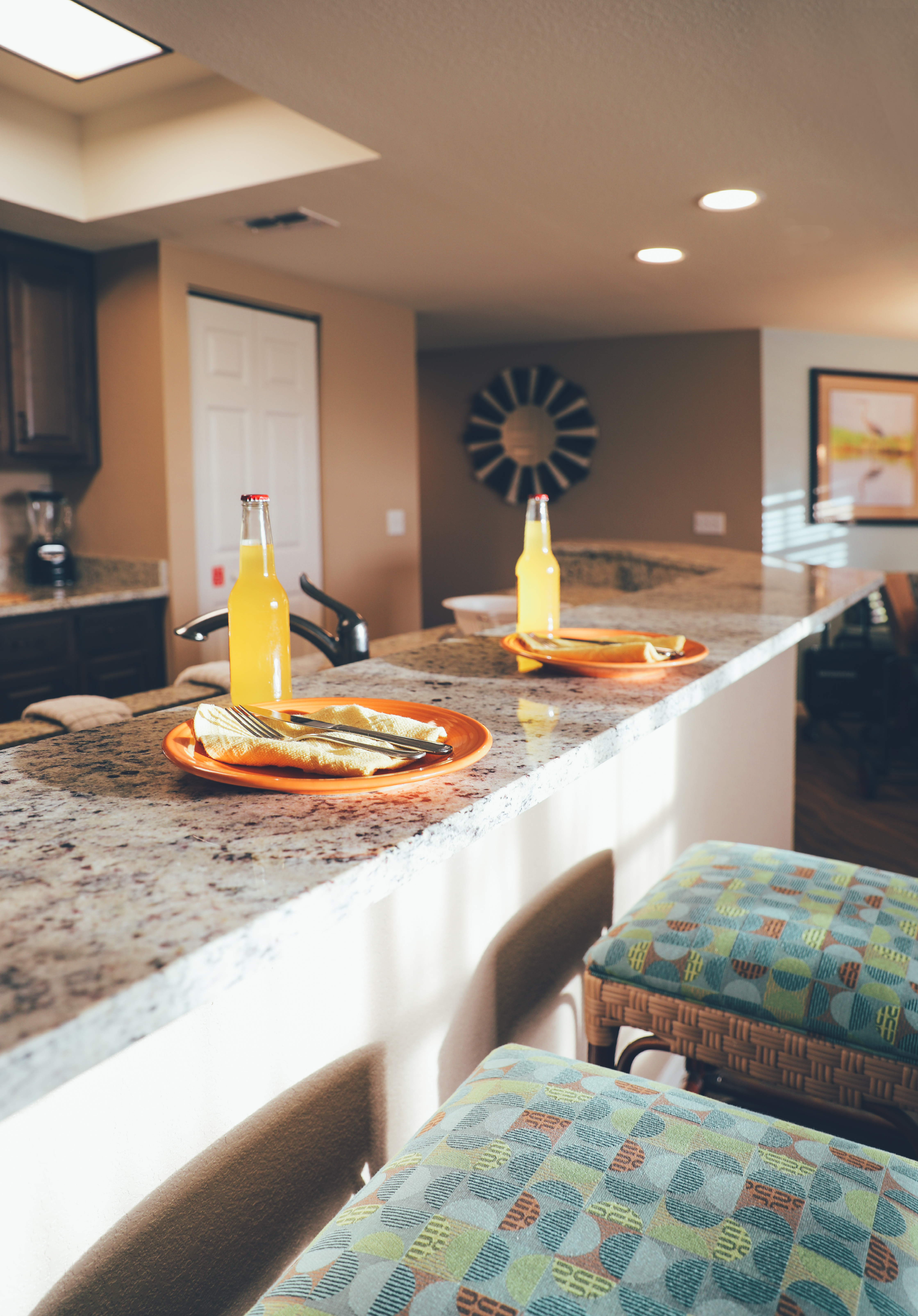 Kitchen bar with two stools and table settings in a villa in North Village at Orange Lake Resort near Orlando, Florida